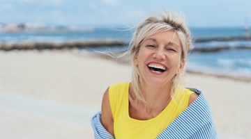 Woman smiling by beach