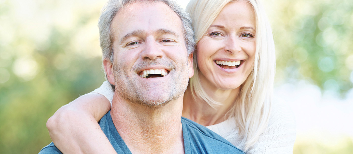 husband and wife smiling