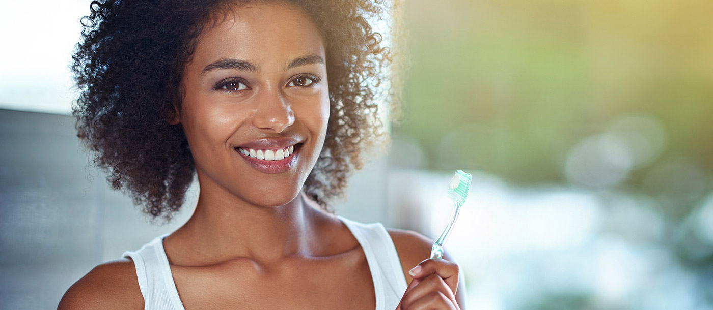 woman holding toothbrush