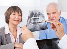 dentist showing patient x-ray