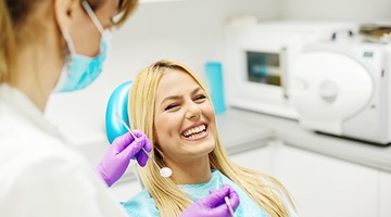 Laughinng woman in dental chair