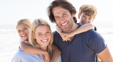 Family smiling at beach