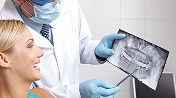 dentist showing woman her x-ray