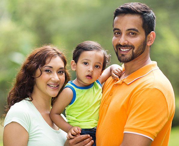 family smiling outside