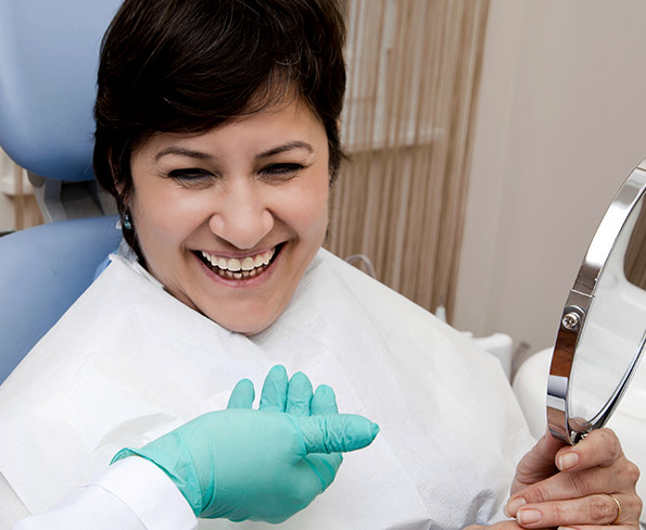 woman smiling looking in mirror