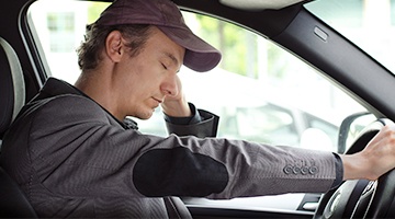 Tired man in his car