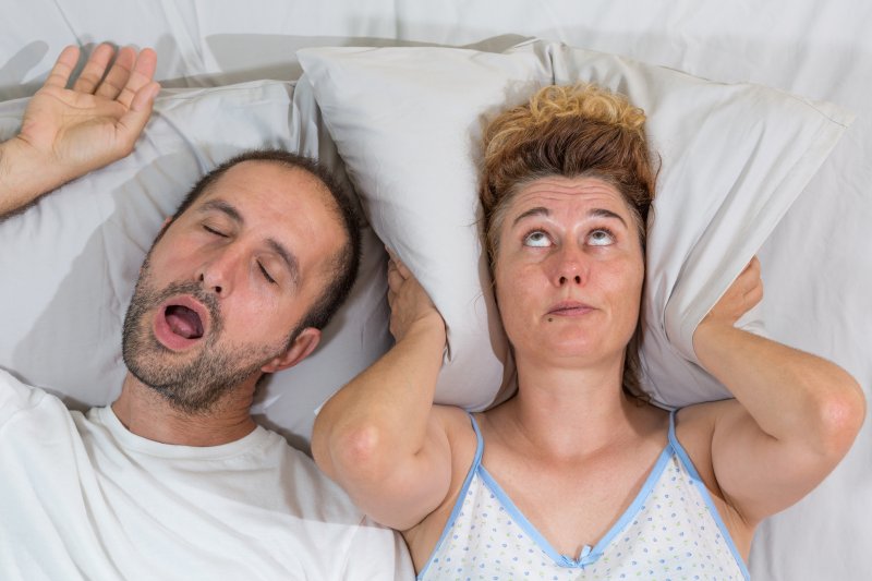 woman upset husband snoring loudly