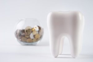 tooth with a savings bank in the background