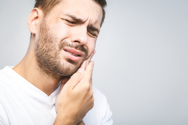 Man with toothache needing to see emergency dentist