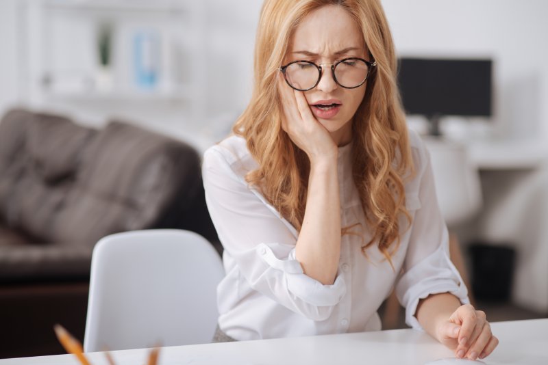 Woman with toothache from cracked tooth